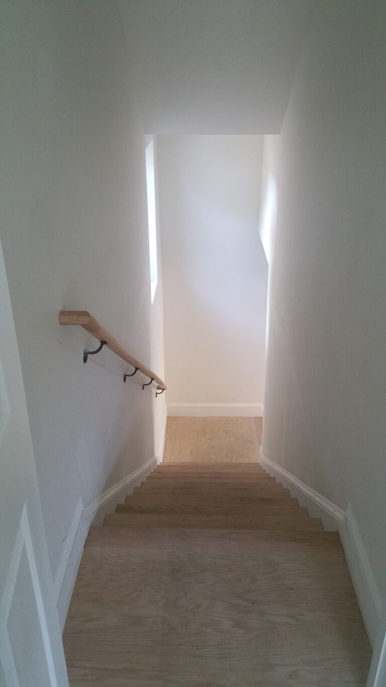 Master Suite above garage interior - Wood finish stairs