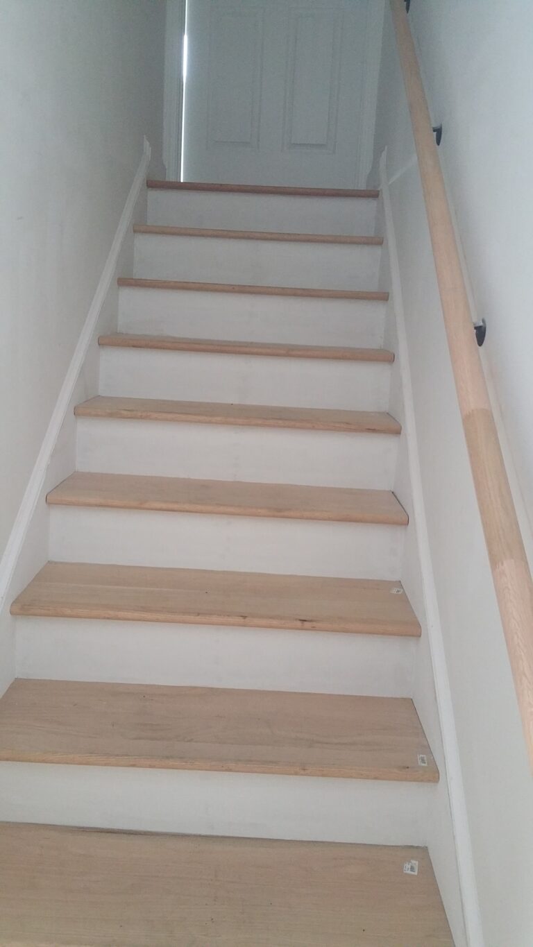 Master Suite above garage interior - Wood finish stairs
